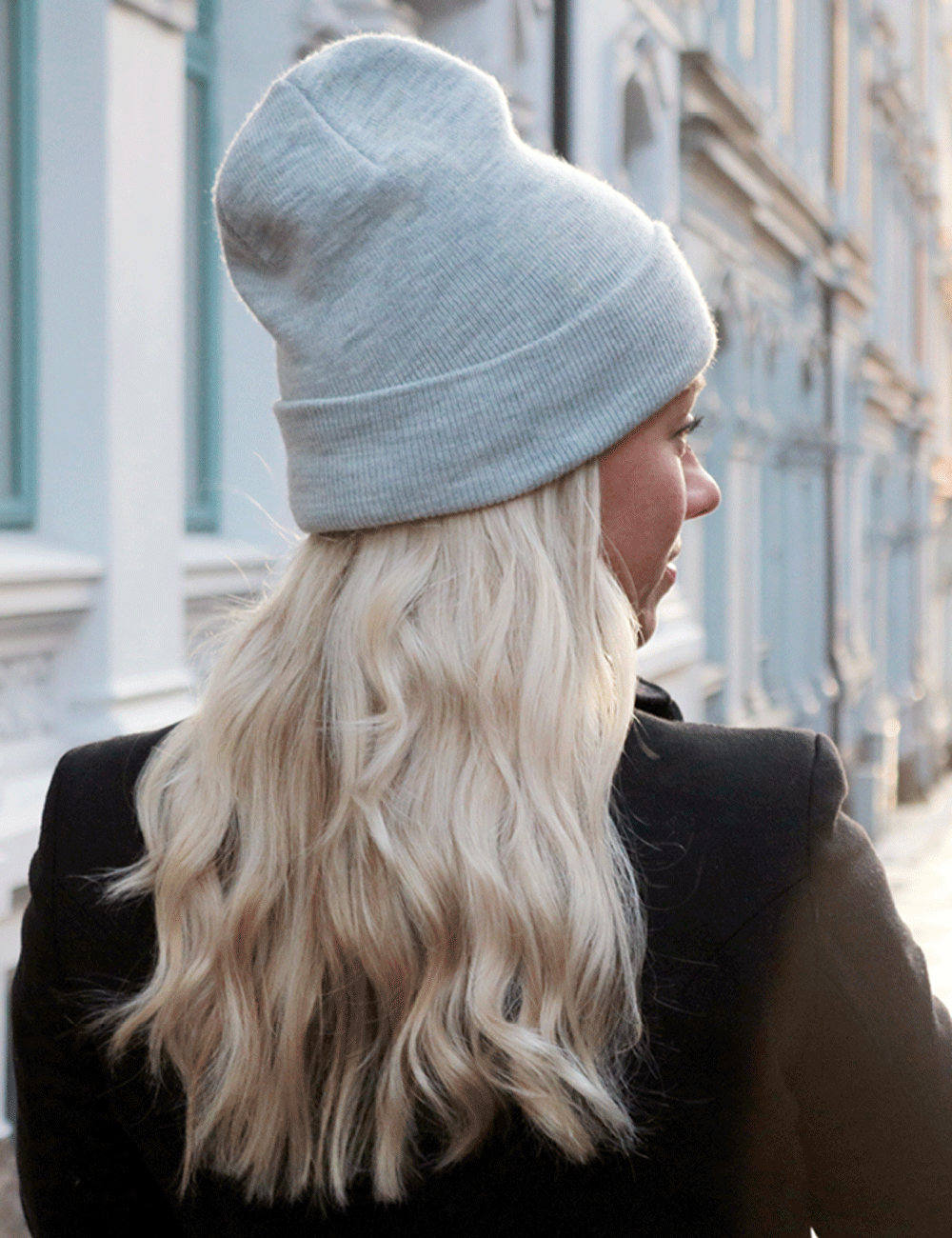 Blondt hår under lue i kaldt vinterlys – typisk årsak til statisk hår.